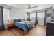 Inviting bedroom featuring a large window and light wood floors at 11744 Magnolia Dr, Thornton, CO 80233