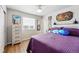 Comfortable bedroom featuring wood floors, a large window, and a chest of drawers at 11744 Magnolia Dr, Thornton, CO 80233