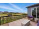 Relaxing outdoor deck area with wicker furniture and views of the yard and neighborhood at 11744 Magnolia Dr, Thornton, CO 80233