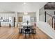 Bright dining area with wooden table, white walls, and stairs to the second level at 11744 Magnolia Dr, Thornton, CO 80233