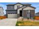 Charming two-story home with a brick entryway, gray siding and an attached garage at 11744 Magnolia Dr, Thornton, CO 80233