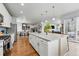 Open-concept kitchen with a large island, stylish pendant lighting, and stainless steel appliances at 11744 Magnolia Dr, Thornton, CO 80233