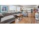 Bright living room with a comfortable gray sectional sofa, wood floors, and modern decor at 11744 Magnolia Dr, Thornton, CO 80233