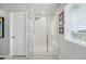 Modern walk-in shower with white subway tile and glass enclosure, featuring natural light at 11744 Magnolia Dr, Thornton, CO 80233