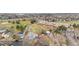 An aerial view shows the deck, fenced-in yard, landscaping, and roof of this home at 15865 E Kepner Dr, Aurora, CO 80017