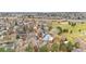 An aerial view shows the deck, fenced-in yard, landscaping, and roof of this home at 15865 E Kepner Dr, Aurora, CO 80017