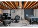 Unfinished basement with exposed beams, concrete walls, and space for a bedroom and office area at 15865 E Kepner Dr, Aurora, CO 80017