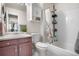 Bathroom features a vanity, toilet, combination shower and bathtub, and unique cabinet above toilet at 15865 E Kepner Dr, Aurora, CO 80017
