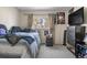 Bedroom includes a full bed, a dresser, a window with curtains, and neutral carpet at 15865 E Kepner Dr, Aurora, CO 80017
