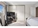 Sunlit bedroom features a large window, sliding closet doors and comfortable carpet at 15865 E Kepner Dr, Aurora, CO 80017