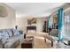 Bright living room with hardwood floors, comfortable seating, and natural light, perfect for relaxation and entertaining guests at 15865 E Kepner Dr, Aurora, CO 80017