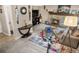 Spacious living room featuring a stone fireplace, entertainment center, exercise bike, and decorative wall art at 15865 E Kepner Dr, Aurora, CO 80017