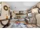 Inviting living room with stone fireplace, wooden mantel, cozy sofa, and colorful rug at 15865 E Kepner Dr, Aurora, CO 80017