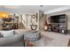 Living room featuring a gray couch, stairs leading to the first floor, and wall decorations at 15865 E Kepner Dr, Aurora, CO 80017