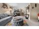 Cozy living room with a gray sofa, ottoman, exercise equipment, and modern décor accents at 15865 E Kepner Dr, Aurora, CO 80017