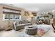 Comfortable living room with tufted ottoman, plush sofa, exercise equipment, and modern decor at 15865 E Kepner Dr, Aurora, CO 80017