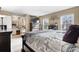 Bright bedroom featuring a large TV, lots of natural light, a vanity, and a dresser at 15865 E Kepner Dr, Aurora, CO 80017