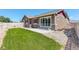 Spacious backyard with a well-kept lawn, concrete patio, and white fence, offering privacy and outdoor enjoyment at 11129 Paradise Ln, Firestone, CO 80504