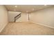 Spacious carpeted basement with stairs and a hallway at 11129 Paradise Ln, Firestone, CO 80504