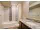 Well-lit bathroom with a tub, shower, and granite countertop at 11129 Paradise Ln, Firestone, CO 80504