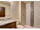 Bright bathroom featuring a walk-in shower and granite countertop at 11129 Paradise Ln, Firestone, CO 80504