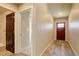 Warm entryway with a red front door, wood-look flooring, and neutral paint, creating a welcoming atmosphere at 11129 Paradise Ln, Firestone, CO 80504