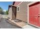 Exterior view of the home featuring a red door, neutral siding, and a well-maintained walkway at 11129 Paradise Ln, Firestone, CO 80504