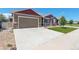 Lovely home with a spacious driveway, attached garage, and a well-maintained front yard and stone accents at 11129 Paradise Ln, Firestone, CO 80504