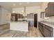 Spacious kitchen with granite island, stainless appliances, dark wood cabinets and sleek modern design at 11129 Paradise Ln, Firestone, CO 80504