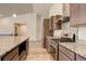 Granite island and countertops, stainless steel appliances and gas range give this kitchen a modern touch at 11129 Paradise Ln, Firestone, CO 80504