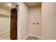 Laundry room with utility connections, a dark wood door, access to closet space and neutral paint at 11129 Paradise Ln, Firestone, CO 80504