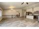 Spacious open-plan living room leading to a kitchen with modern appliances and a breakfast bar at 11129 Paradise Ln, Firestone, CO 80504