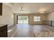 Bright living area featuring a ceiling fan, chandelier, and sliding glass door leading to a patio at 11129 Paradise Ln, Firestone, CO 80504