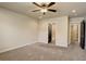 Bedroom showing doorways to ensuite bathroom and closet space, carpet, and neutral walls at 11129 Paradise Ln, Firestone, CO 80504