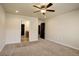 Bedroom featuring carpet, access to the bathroom, neutral walls, and a ceiling fan at 11129 Paradise Ln, Firestone, CO 80504