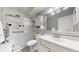 Bright bathroom with a glass-enclosed shower, white vanity, and large mirror at 13626 E Bates Ave # 302, Aurora, CO 80014