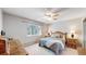 Cozy bedroom with a ceiling fan, large window, and nicely finished wood furniture at 13626 E Bates Ave # 302, Aurora, CO 80014