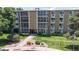 Inviting condo building with well-maintained landscaping, walkway, and building signage at 13626 E Bates Ave # 302, Aurora, CO 80014
