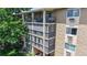A multi-story tan building with balconies, providing outdoor living space and natural light at 13626 E Bates Ave # 302, Aurora, CO 80014