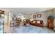 Bright living room with wood floors, neutral paint, and seamless flow to kitchen area at 13626 E Bates Ave # 302, Aurora, CO 80014