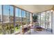 Enclosed sunroom with views, wood table set, comfortable seating and natural light at 13626 E Bates Ave # 302, Aurora, CO 80014