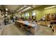 Brightly lit workshop with workbenches, stools, and tool storage at 13626 E Bates Ave # 302, Aurora, CO 80014