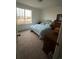 Bright bedroom with large window and carpeted floor at 16411 E 111Th Dr, Commerce City, CO 80022