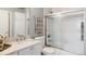 Cozy bathroom featuring a sink, toilet, and bathtub-shower combo with a sliding glass door at 5301 S Birch Ct, Greenwood Village, CO 80121