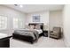 Neutral bedroom featuring a bed with side tables, lamps, and an armchair at 5301 S Birch Ct, Greenwood Village, CO 80121