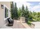 Inviting deck with a bench, wrought iron railing, and serene treetop views at 5301 S Birch Ct, Greenwood Village, CO 80121