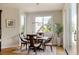 Bright dining room featuring a round table, wood floors, natural light, and elegant decorative details at 5301 S Birch Ct, Greenwood Village, CO 80121