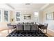 Bright dining room featuring a large table, modern light fixture, and hardwood floors at 5301 S Birch Ct, Greenwood Village, CO 80121
