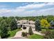 Beautiful home on a large lot with lush landscaping, circular driveway, and a three-car garage at 5301 S Birch Ct, Greenwood Village, CO 80121