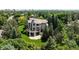 Stunning home featuring mature trees, a large yard, and a spacious deck perfect for outdoor entertaining at 5301 S Birch Ct, Greenwood Village, CO 80121